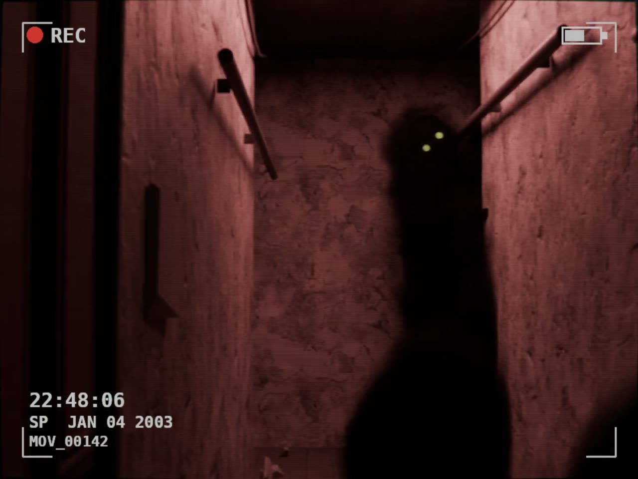 A still from a found-footage Blender render: a dark figure with lit eyes standing in a corridor, seen through a camcorder overlay